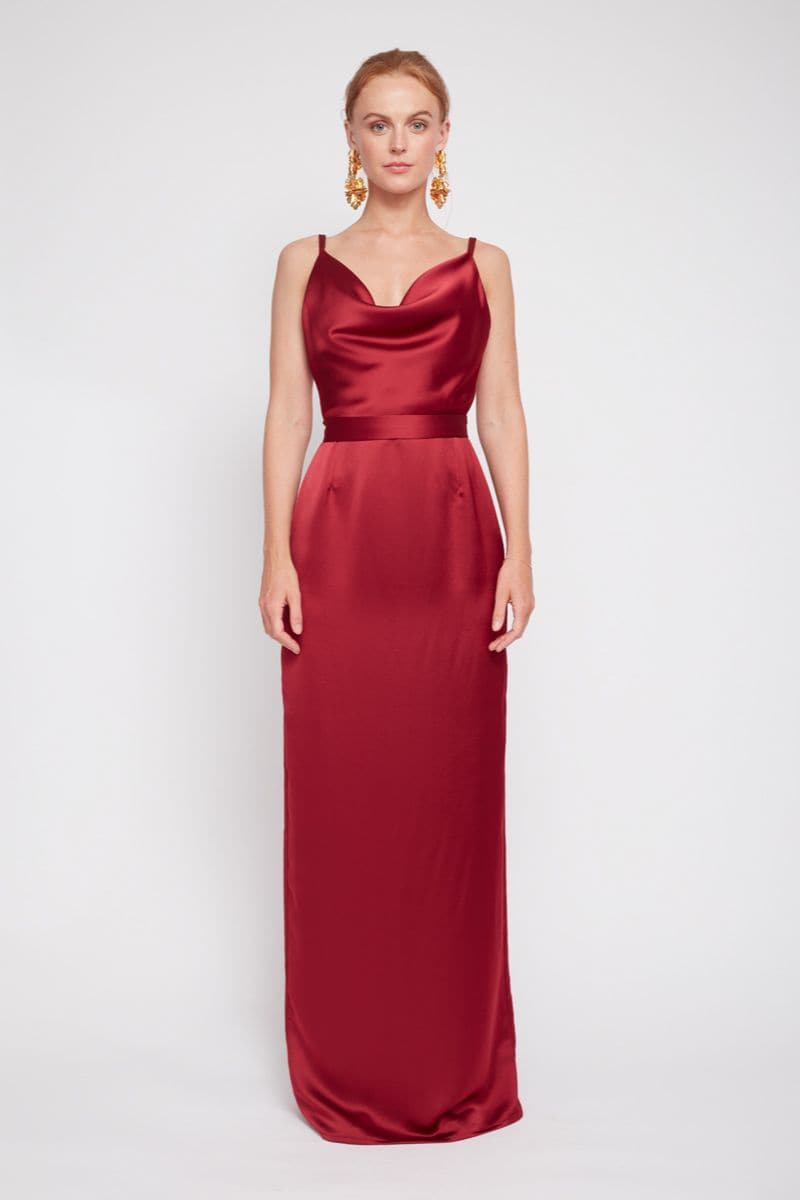 Undress Amila deep red backless maxi dress displayed on a model, featuring a flowing silhouette and elegant design.