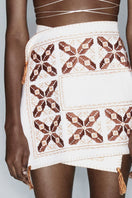 Maxi skirt with cross design and hand embroidery by JC Pajares, showcasing intricate embroidery details and flowy fabric.