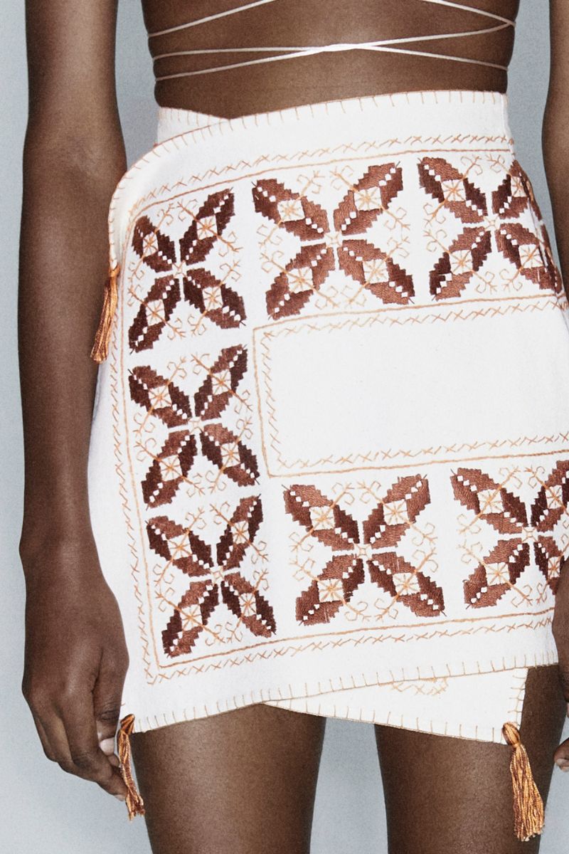 Maxi skirt with cross design and hand embroidery by JC Pajares, showcasing intricate embroidery details and flowy fabric.