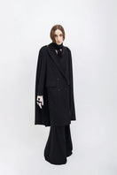 Black Vaska coat with long design and zip-on detachable scarf, showcasing a stylish and versatile outerwear piece.