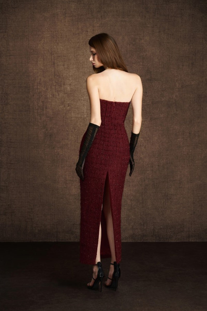 Keira Tong bustier tweed midi dress displayed on a hanger, showcasing its fitted bodice and textured fabric.