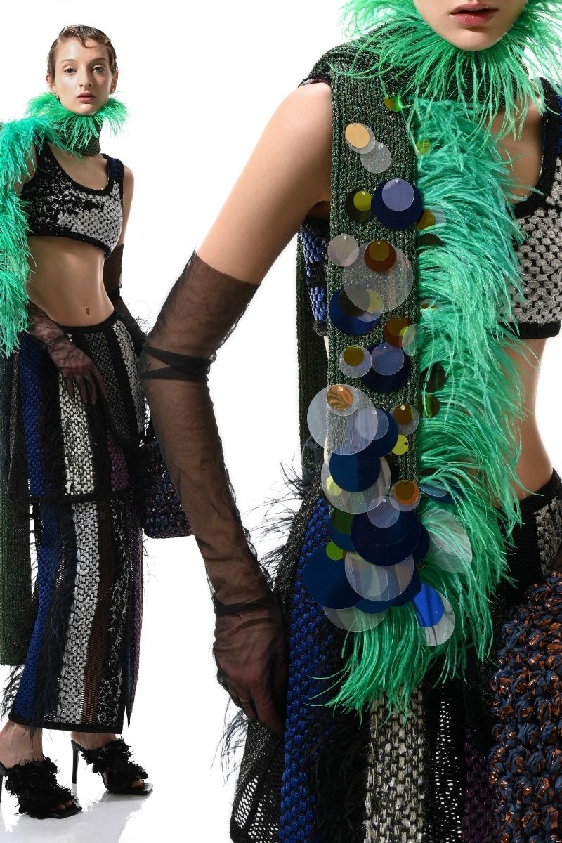 Hand-knitted green scarf with embellishments from Lalo, showcasing cozy texture and intricate detailing in a close-up view.