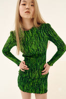 Green printed mini skirt with shirred design from Chictopia, featuring a fitted waist and vibrant floral pattern.