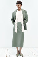 PODYH MEREZHYVO green jacket, stylish outdoor jacket with a zip-up front and adjustable hood, shown on a hanger.