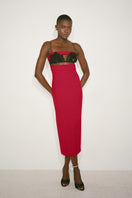 Nué Paloma midi dress displayed on a hanger, featuring a flowy fabric and elegant design perfect for stylish occasions.