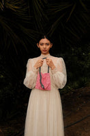 Pink SAC DE SOUL Serpent Small shoulder bag with black and white accents, featuring a textured snake pattern and compact design.