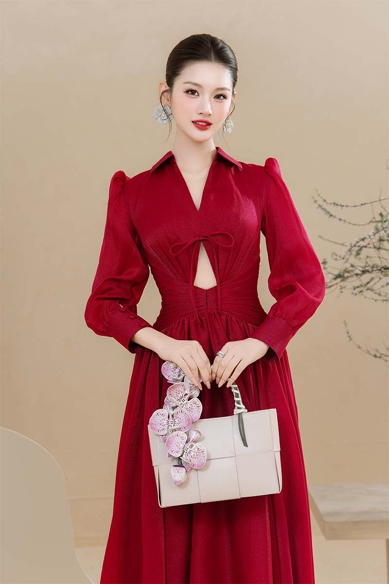 Do Long Scarlet Serenity maxi dress hanging on a hanger, showcasing its flowing fabric and vibrant red color.