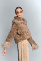 Beige cropped faux fur jacket with turn-up cuffs by Fortini, featuring a soft, plush texture and stylish design.