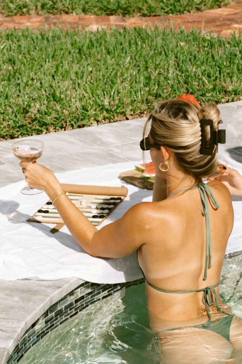 Travel backgammon board in Tulum design by Throwing Doubles, featuring colorful game pieces on a wooden playing surface.