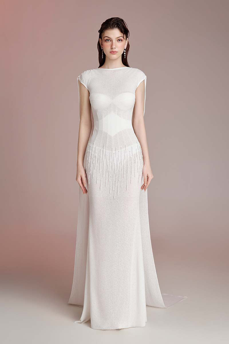 Long white maxi dress by Do Long featuring a flowing design and elegant silhouette, perfect for formal or casual occasions.