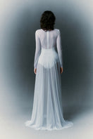 White Plan Nirvana Dress gown with flowing fabric and elegant design, displayed on a mannequin.