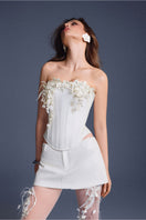 White Bouquet Corset Top by Keira Tong featuring a fitted design and floral-inspired detailing on a model.