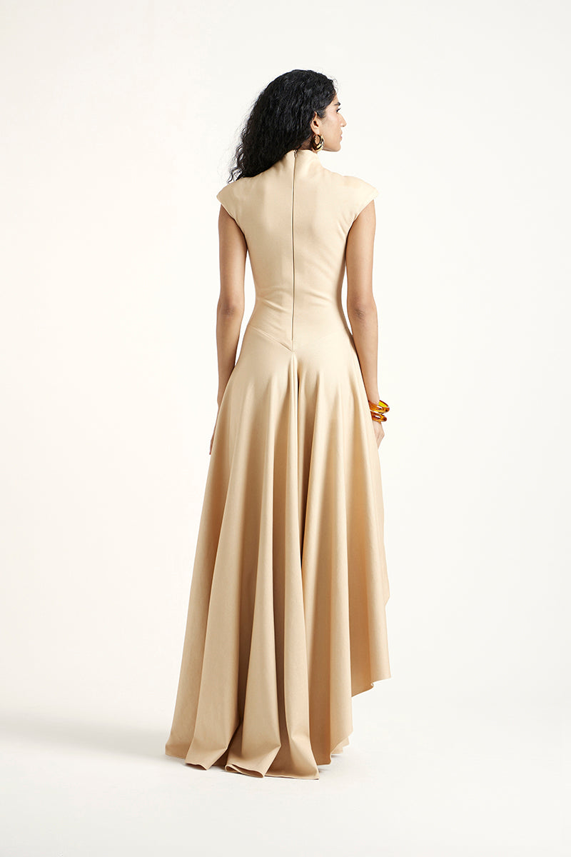 Deme By Gabriella gold maxi dress with elegant flowing fabric and sleeveless design, perfect for formal occasions.