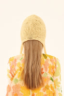 Hand-knitted yellow bonnet hat by Chictopia, featuring a cozy, textured design perfect for stylish winter wear.