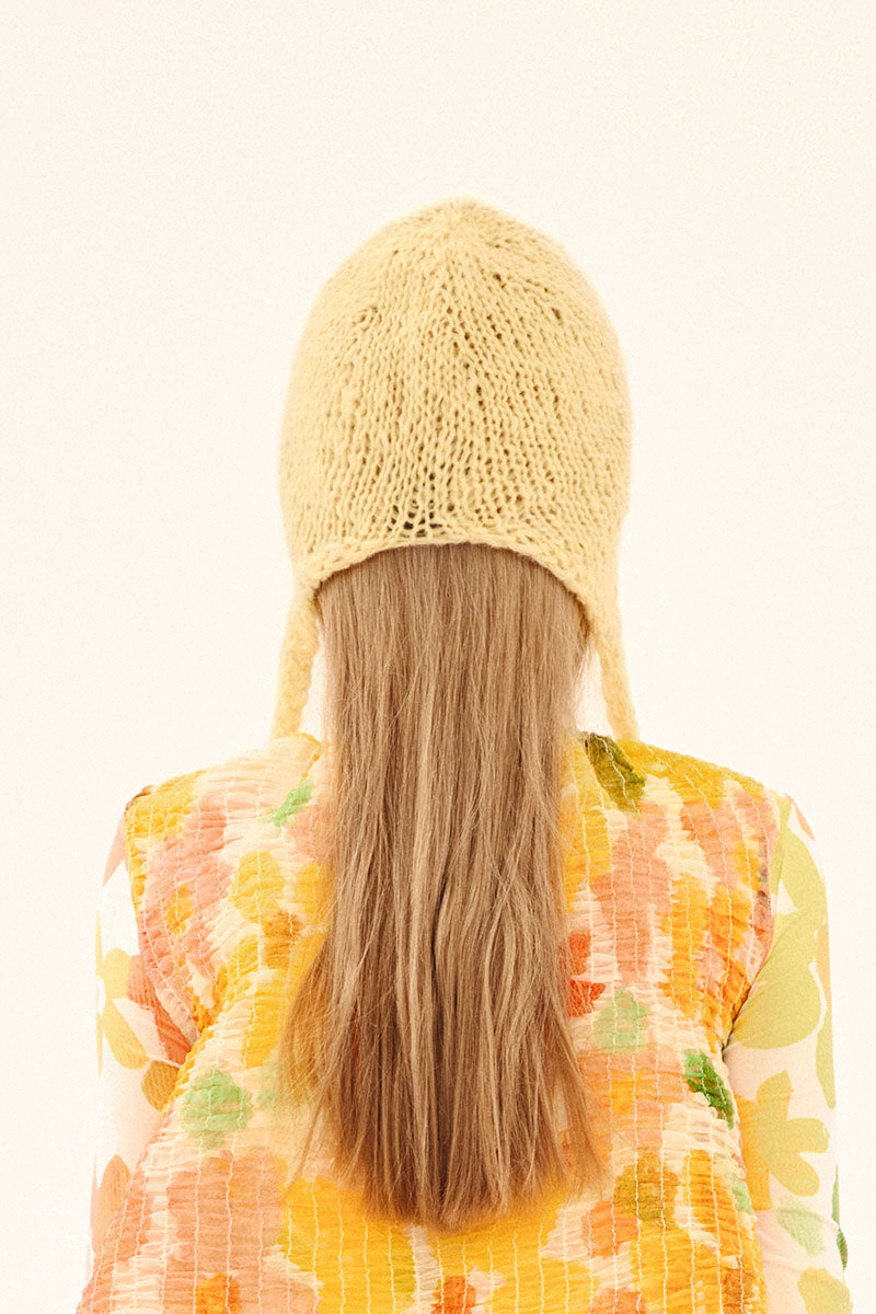 Hand-knitted yellow bonnet hat by Chictopia, featuring a cozy, textured design perfect for stylish winter wear.
