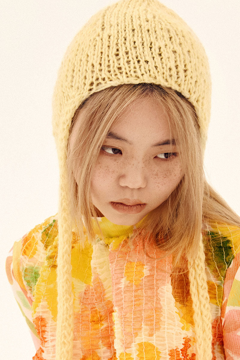 Yellow hand-knitted bonnet hat by Chictopia, featuring a cozy, textured knit design perfect for stylish warmth.