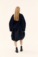 Chictopia sculpted black volume jacket featuring structured design and padded details, perfect for contemporary fashion.
