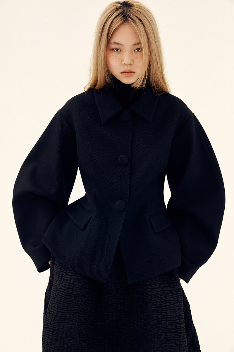 Chictopia sculpted black volume jacket featuring structured design and modern style, displayed on a hanger.