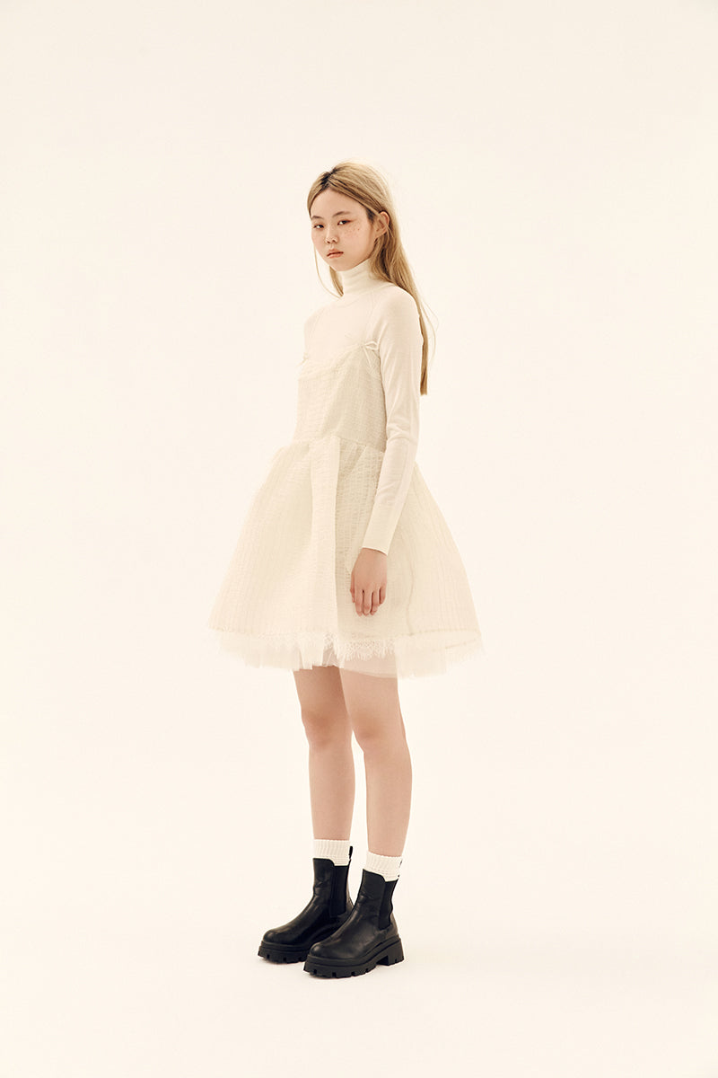 Ethereal ivory silk shirred mini dress by Chictopia with delicate ruffle details and a flowing, elegant silhouette.