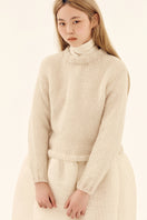 Light gray hand-knitted sweater by Chictopia, featuring a cozy, textured knit pattern and long sleeves.