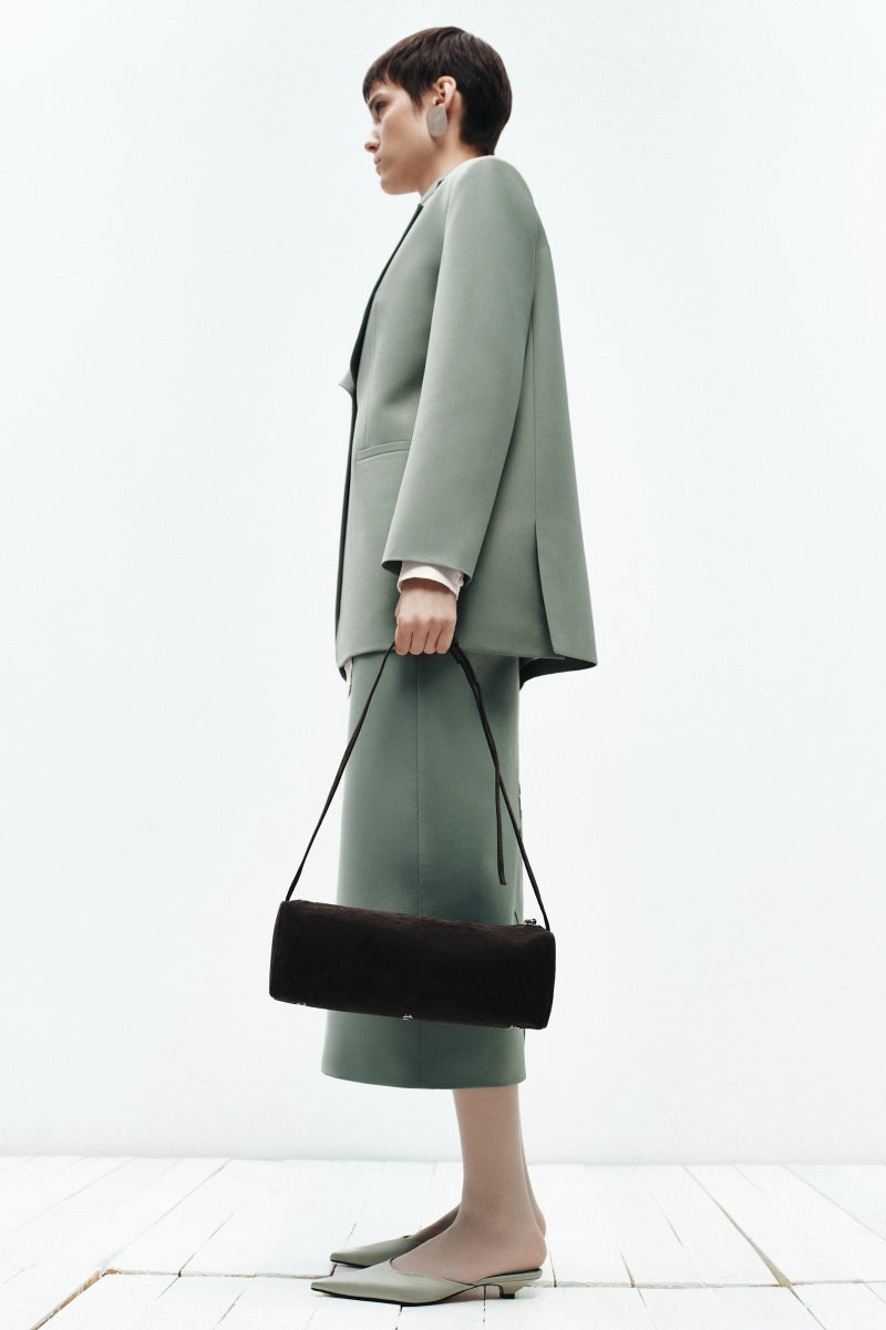Brown PODYH KOLODA top handle bag with sleek design, featuring a structured shape and elegant handle for stylish carry.