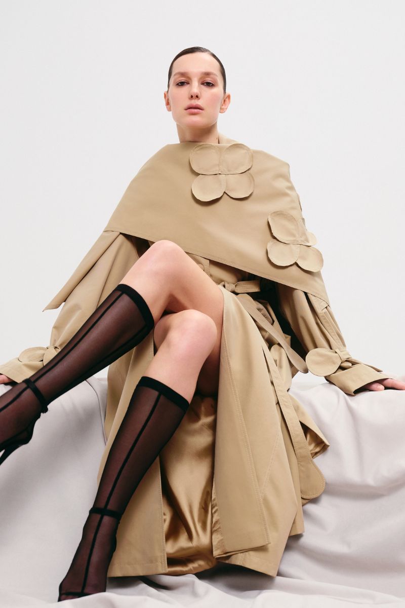 Beige relaxed trench coat by Malva Florea with a detachable scarf, stylish and comfortable for cooler weather.