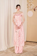Pink lace Ao Dai co-ord set with feather details by Do Long, featuring intricate lace fabric and elegant design.