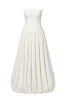 Ivory Whisper gown by TONYY displayed on a hanger, featuring a flowing fabric and elegant design perfect for formal occasions.