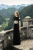 Black Stone Orchid asymmetric shoulder gown with cape by Tracy Studio, featuring elegant draping and intricate design details.