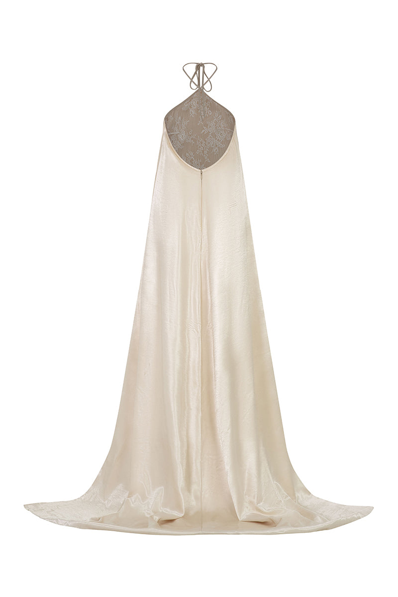 Cream halterneck pleated maxi gown by Valenciani, featuring elegant pleats and flowing fabric for formal occasions.