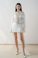 White sheer organza shirt from DOC BAN, featuring lightweight, transparent fabric with a classic collar and long sleeves.