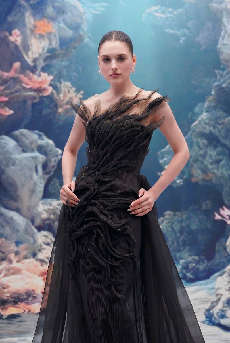 Black tulle and organza gown by 21Six, featuring elegant layered fabric and a flowing silhouette.