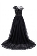 Black Sedna tulle and organza gown by 21Six, flowing elegant dress with layered fabric and intricate design details.