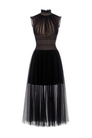 Black tulle high-neck semi-sheer gown by Rosee De Matin, featuring elegant flowing fabric and stylish design.