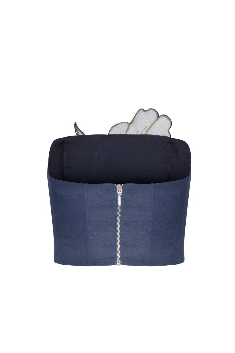 Navy tulip top by Estefania featuring a fitted silhouette and floral design, displayed on a hanger against a plain background.