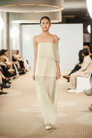 Light vanilla-toned TONYY maxi dress with draped fabric and flowing silhouette, perfect for elegant summer occasions.