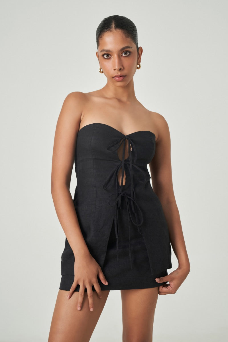 Black Lagos top by Summer Away, sleeveless and stylish, shown on a model with a close-up view of the fabric and neckline.