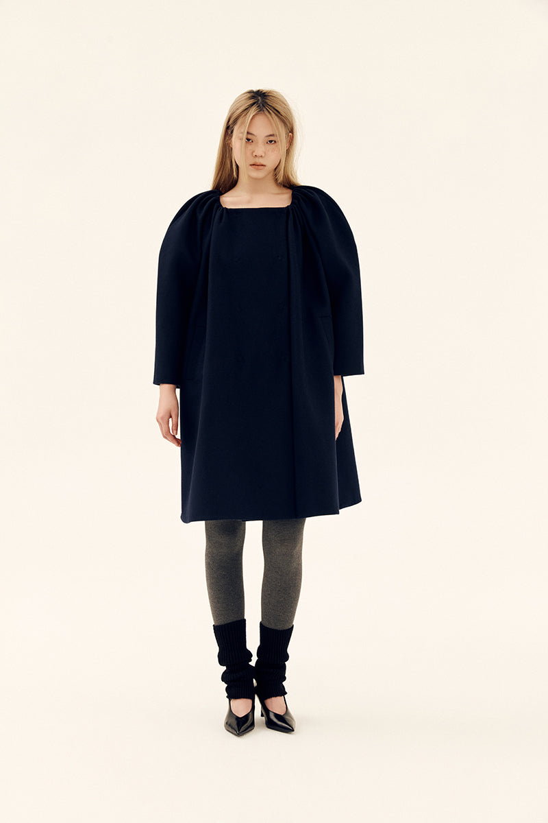 Chictopia midnight cocoon coat in navy, stylish and cozy outerwear with a relaxed fit, displayed on a hanger.