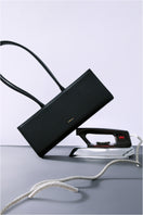 Black POELLE CECILIE top handle bag with sleek design and sturdy handles, perfect for stylish everyday use.