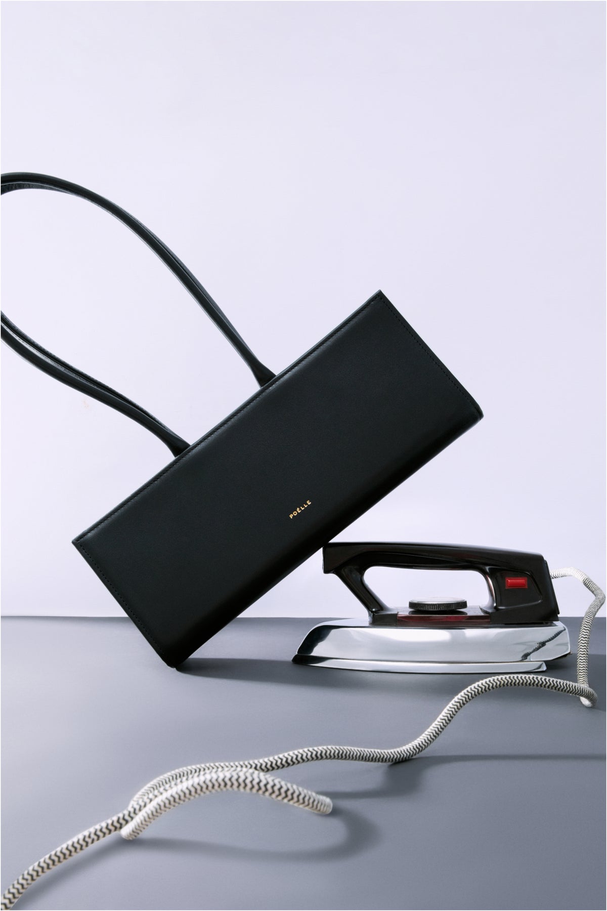 Black POELLE CECILIE top handle bag with sleek design and sturdy handles, perfect for stylish everyday use.