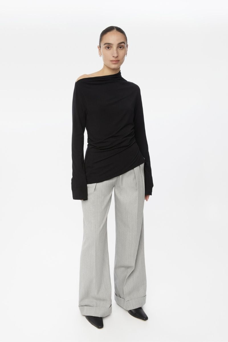 Dāl the Label modal asymmetric knit top shown from the front, featuring a stylish, uneven hem and soft fabric in a modern design.