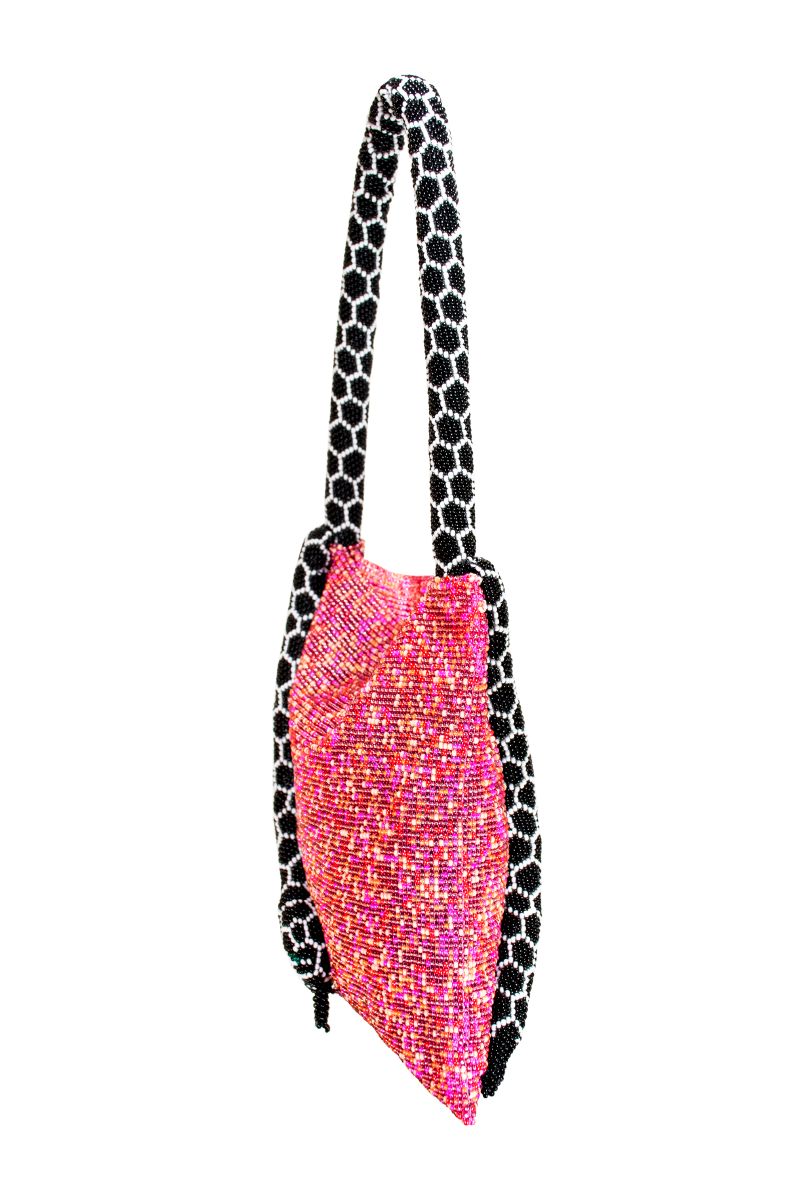 Pink Serpent small shoulder bag by SAC DE SOUL with black and white accents, featuring a textured snake pattern and compact design.