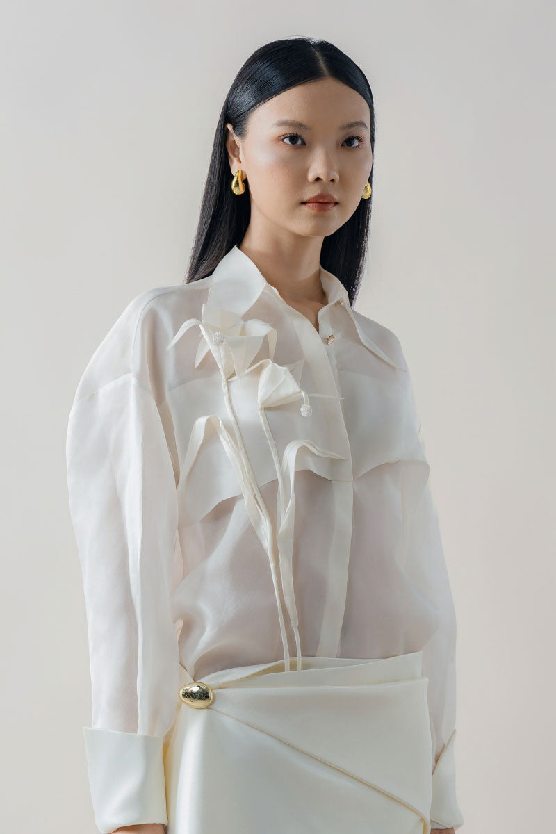White sheer organza shirt by DOC BAN, featuring lightweight, transparent fabric and classic shirt design with collar and button front.
