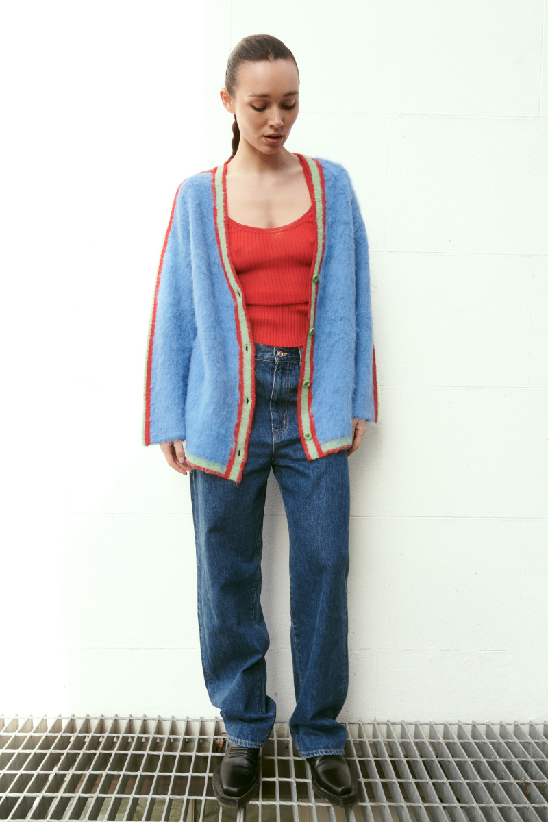 Baby blue oversized multicolored Suri cardigan by La Granni, featuring a cozy knit with vibrant patterns and a relaxed fit.