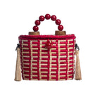 Red Catarina Mina Jirau top handle basket bag with sturdy handles and spacious interior.