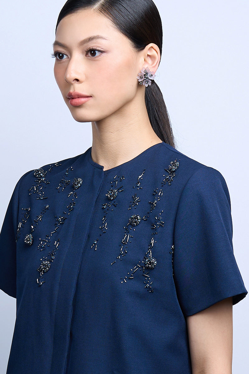 A pair of Mellow Purple Earrings by Aidan & Ice featuring vibrant purple earrings with a stylish, modern design.
