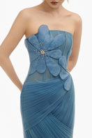 Blue 3D floral draped maxi gown by Happy Clothing, featuring flowing fabric and elegant floral detailing.