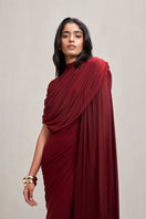 Deme By Gabriella Dianna gown in deep burgundy fabric with elegant drape and long sleeves, suitable for formal occasions.