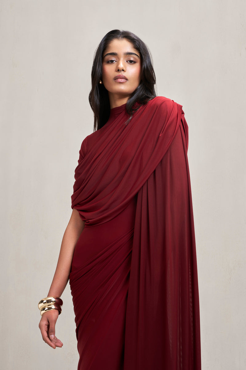 Deme By Gabriella Dianna gown in deep burgundy fabric with elegant drape and long sleeves, suitable for formal occasions.