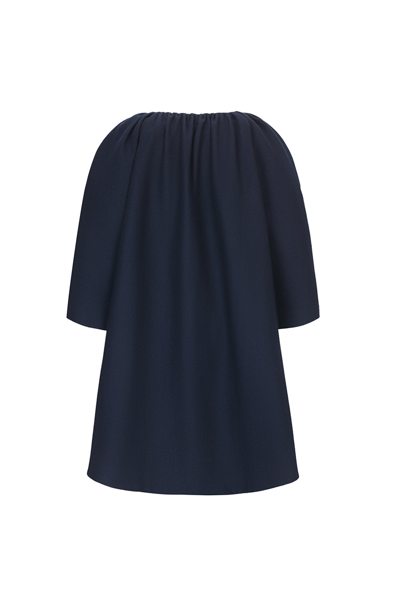 Navy midnight cocoon coat by Chictopia hanging on a clothing rack, showcasing its oversized, cozy silhouette and smooth fabric.